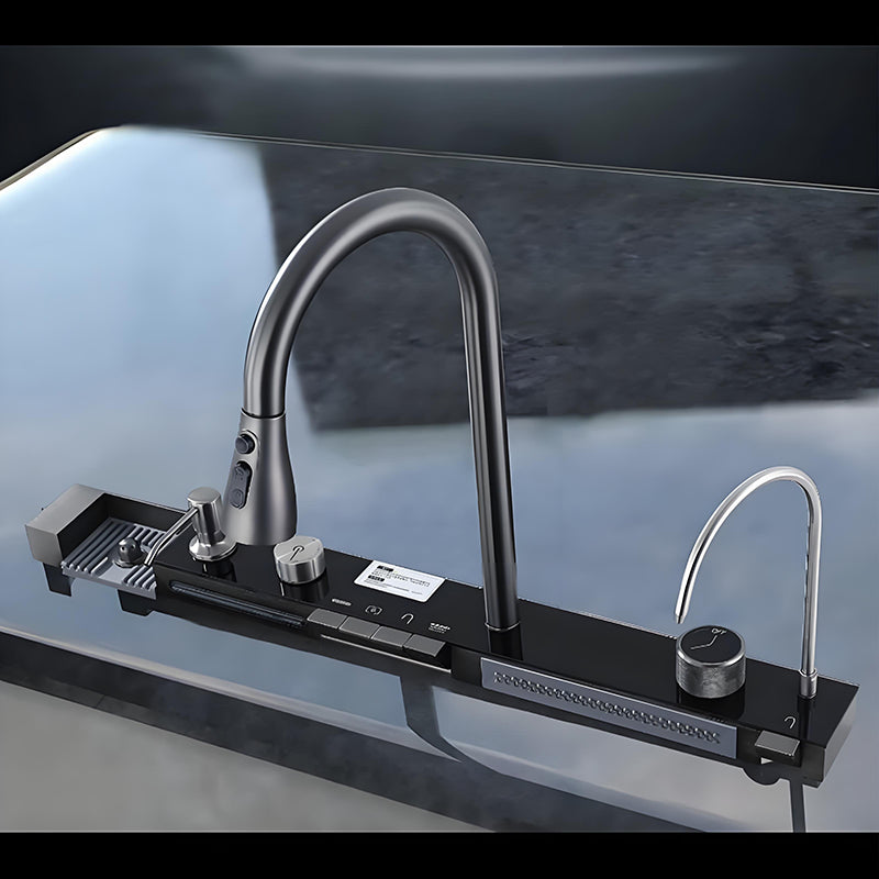 Close-up of smart stainless steel kitchen sink rear control rail with high-arc faucet, control buttons, rotary knob, waterfall outlet, auxiliary faucet, and integrated accessory panel.