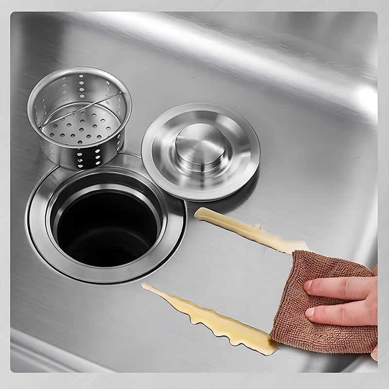 Close-up of stainless steel kitchen sink drain system with removable strainer basket, round drain cover, smooth brushed surface, and easy-clean wiping demonstration.