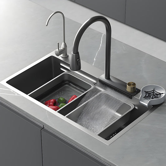 Gray waterfall multifunctional stainless steel kitchen sink with pull-down faucet, side faucet, drain basket, auxiliary basin, and wide waterfall rinsing outlet for food preparation.
