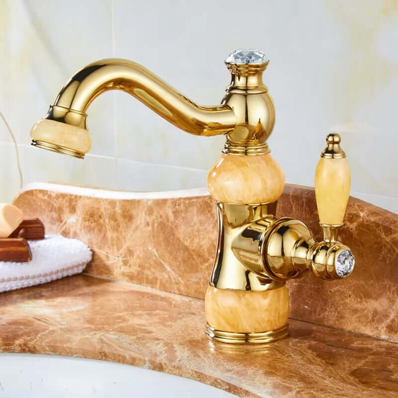 Luxury golden basin faucet with unique design and single handle on marble countertop.