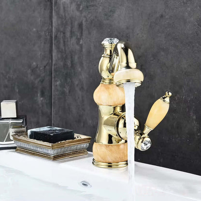 Luxury golden basin faucet with unique design and single handle in modern bathroom setting.