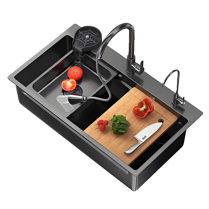 Black multifunctional stainless steel workstation kitchen sink with faucet, pull-out sprayer, wooden cutting board, vegetable washing area, and integrated accessory ledges for modern kitchen use.