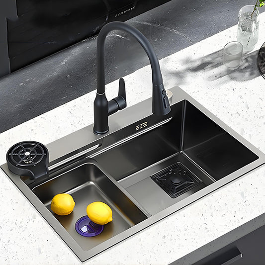 Dual-zone multifunctional stainless steel workstation kitchen sink installed in a white countertop, featuring a black pull-down faucet, small inner basin, large washing bowl, and modern prep-friendly layout.