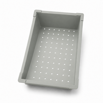 Grey movable filter basin for multifunctional kitchen sink with perforated bottom.