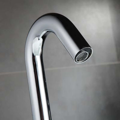 Close-up of a sleek, modern countertop-mounted sink faucet with automatic sensor technology.