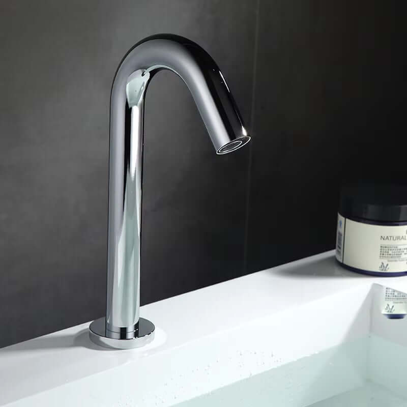 Countertop mounted automatic sensor faucet in sleek chrome finish, blending modern design with hygienic water use.