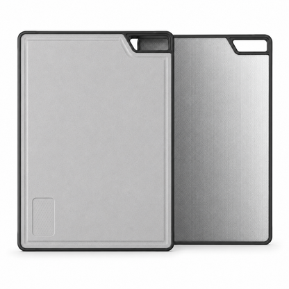 Two-sided sink cutting board display with wheat fiber cutting surface in front and textured stainless steel side behind, designed for sliding use on workstation kitchen sinks.